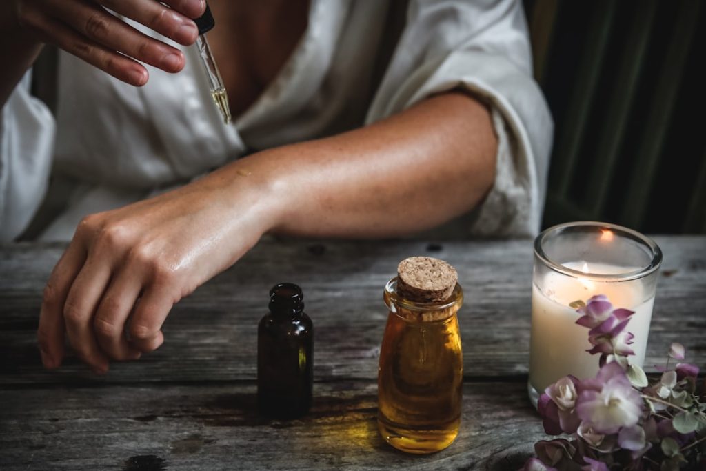 Natural herbal remedies for skincare and health using essential oils and candles at home.
